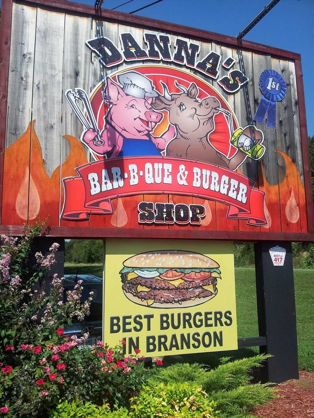 Une enseigne pour le restaurant Danna's BBQ & Burger Shop, avec une grande illustration de hamburger et l'inscription « Les meilleurs hamburgers de Branson ».