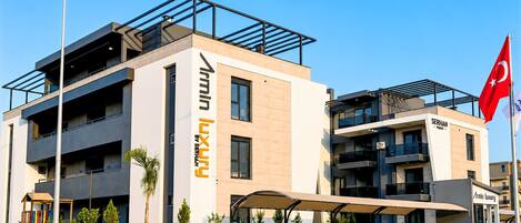 A modern building with a prominent sign for 'Serhan Luxury by Serhan.'