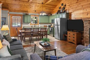 A cozy living room with a sofa, a coffee table, and a television. - Luxury in the Ozarks! 4 Master Suites, 3 Pools, 2 Spacious Living Areas - 19 (Branson)