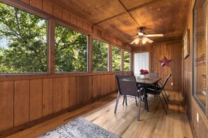 A wooden-paneled room with a dining table, chairs, and a ceiling fan. - Luxury in the Ozarks! 4 Master Suites, 3 Pools, 2 Spacious Living Areas - 19 (Branson)