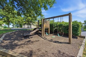 A playground with a slide and swings. - Fantastic 3-bedroom condo in charming Gatlinburg near Ober Gatlinburg (Gatlinburg)
