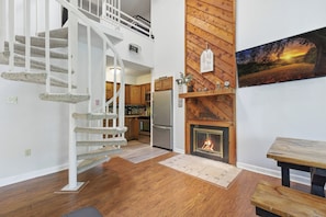 A modern kitchen with a built-in fireplace, wooden accents, and a staircase. - Fantastic 3-bedroom condo in charming Gatlinburg near Ober Gatlinburg (Gatlinburg)