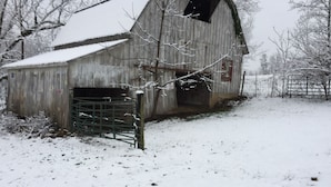 A barn with a metal gate and snow-covered ground. - Welcome to Orchard Farms!  Looking for a Farm/Homestead experience or getaway? (Summerville)
