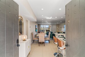A modern interior with a dining area, kitchen, and living space. - Desert Elegance Off El Paseo (Palm Desert)
