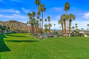 A resort with a pool, palm trees, and a mountainous backdrop. - Desert Elegance Off El Paseo (Palm Desert)
