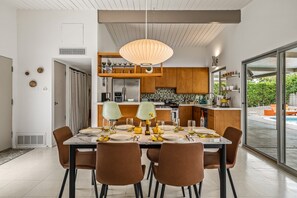 A modern kitchen with a dining area set for a meal. - The Orchid Tree Inn, Est. in 2026, Central Palm Springs, A Mid-Century Beauty (Palm Springs)