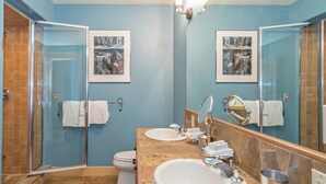 A bathroom with a glass shower enclosure, two sinks, a toilet, and a large mirror. - Diamondtooth 3 3 Bedroom/ 3 Bathroom Downlown Condo (Telluride)