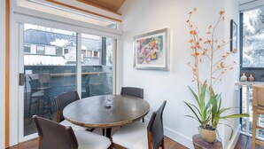 A dining area with a round table, chairs, and a potted plant. - Telluride Lodge Condo 323 (Telluride)