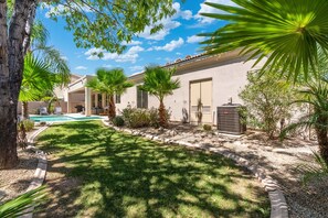 A residential property with a swimming pool, palm trees, and a covered patio area. - Redfield Ridge l Spacious 4BR Home l Pool (Phoenix)