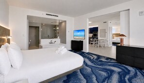 A hotel room with a large bed, a bathroom with a sink and mirror, a TV, and a view of the sea. - W Resort | Largest Corner | 1,737 SF | 270° Views (Fort Lauderdale)
