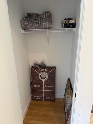 A small room with a loft bed, a shelf with a puzzle box, and a wooden box labeled 'Social' with options like 'Waterfall' and 'Take A Drink'.