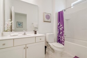 A modern bathroom with a white sink, toilet, and shower area. - SunnyView Residence (Davenport)