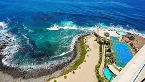 A coastal resort with a beach, a pool, and a tennis court. - 16th-Floor Oceanfront Condo with Stunning Sunset Views (Playas de Rosarito)