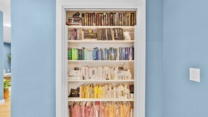 A bookshelf with various books and decorative items.