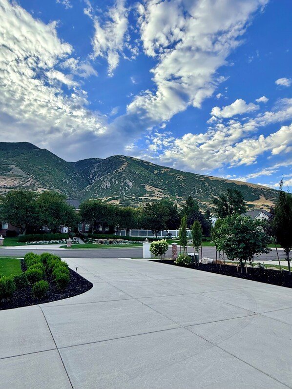 A paved area with a mountain in the background and a clear sky.