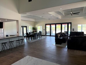 A spacious living area with a kitchen, dining table, and seating. - Hacienda Bonita (Del Rio)