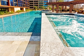 A swimming pool with a clear water section and a jacuzzi area. - Ocean View 2BR/2BA at ONE Ala Moana — With 2 Parking Stalls & Resort Amenities (Honolulu)