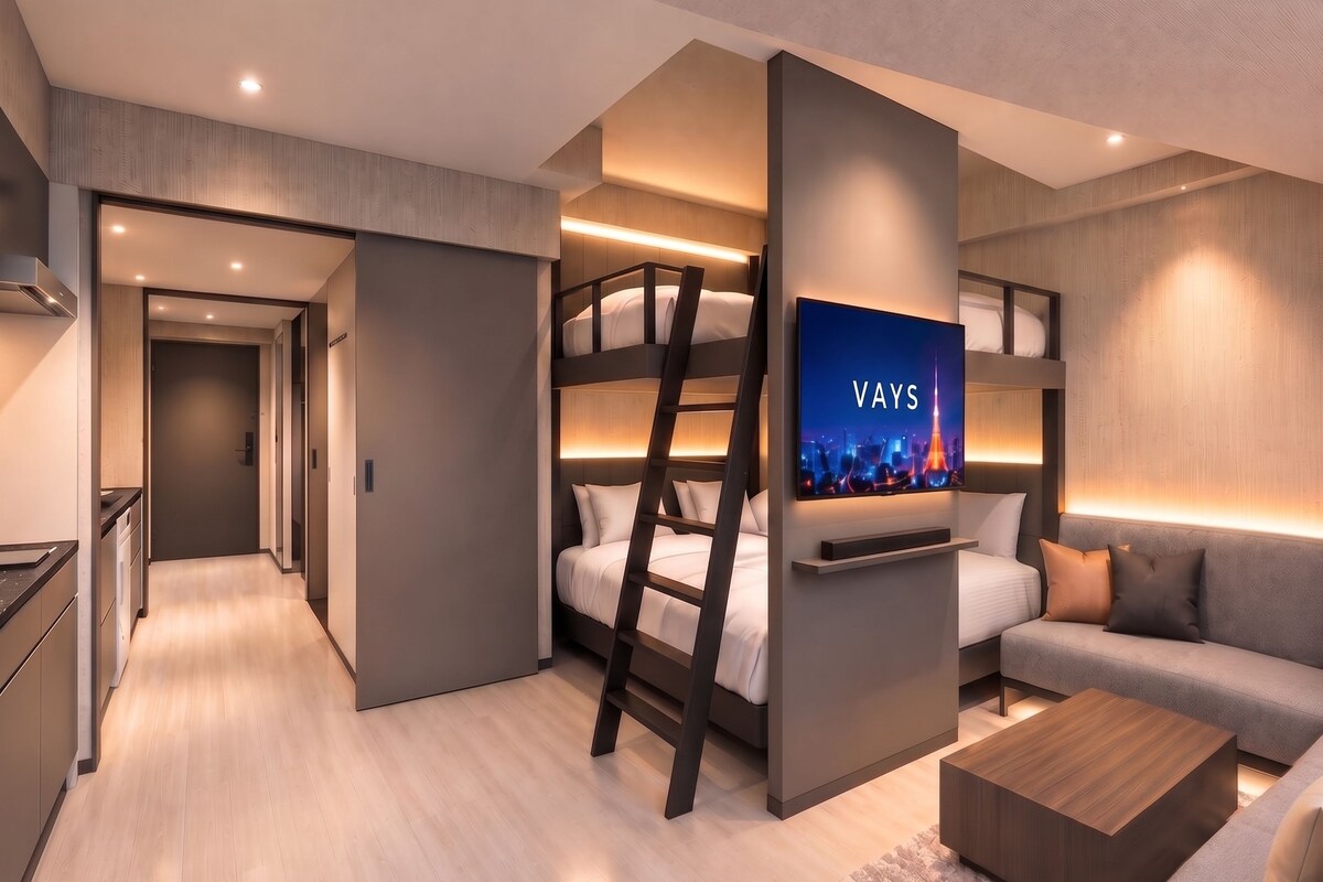 A modern hotel room with a bunk bed, a flat-screen TV, a sofa, and a coffee table.