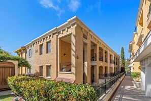 A multi-story building with a beige facade, numbered 1010, featuring balconies and a central entrance. - Cozy 3-Suite condo with AC in gorgeous La Jolla, CA.  Owner lives there summers. (San Diego)