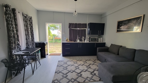 A compact living space with a kitchenette, a dining area, and a sofa. - New Listing-Bungalow Verde Unit Two (Castries)