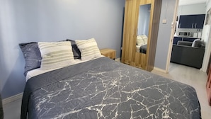 A bedroom with a bed, a wardrobe, and a kitchenette in the background. - New Listing-Bungalow Verde Unit Two (Castries)
