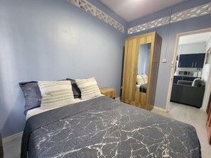A bedroom with a bed, a wardrobe, and a kitchenette in the background. - New Listing-Bungalow Verde Unit Two (Castries)