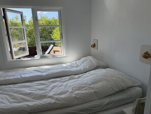 A room with a bed, a window, and a wall-mounted light fixture. - "Andrina" - 490m from the sea by Interhome (Sæby)