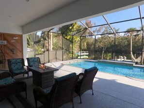 An outdoor pool area with seating and a view of the surrounding landscape. - Crystal River Waterfront w/ Dock, Pool & Manatees! (Crystal River)