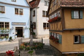 A traditional European street with a building labeled 'Gasthof Glocke.' - Glocke (Rothenburg ob der Tauber)