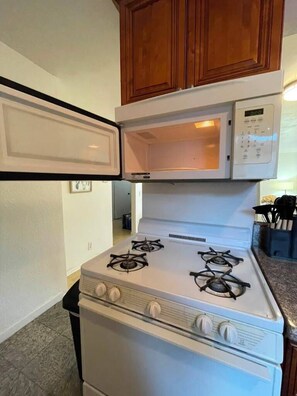A compact kitchen with a stove, oven, and microwave. - 2 Bedroom Apt 5 minutes from Rodeo Dr Walk to Restaurants and Markets (Beverly Hills)
