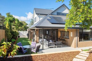 A residential property with a covered patio, outdoor seating area, and solar panels on the roof. - The Milly (Dunsborough)