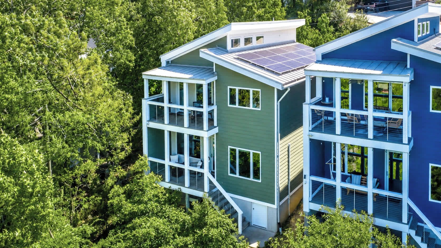 A modern multi-story building with large windows and a flat roof.