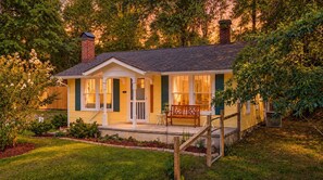 A single-story house with a porch, a chimney, and a small garden area. - Lucky's Cottage | Hot Tub+Dog Friendly+Fire Pit (Rossville)