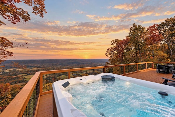 A hot tub on a wooden deck with a view of a valley and trees. - Crossbow Cabin | Lookout Mountain • Stunning Views (Rising Fawn)