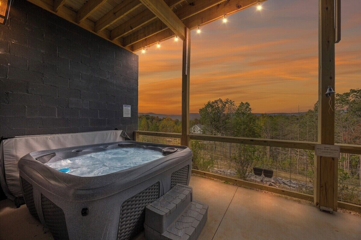 A hot tub in a covered outdoor area with a view of the landscape.
