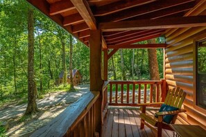 A wooden cabin with a porch overlooking a forest. - Hideaway Lodge | 2BR Nature Retreat | Hot Tub! (Trenton)