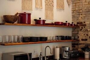 Open shelves stocked with cookware and glassware - Saint Elmo Loft | Upscale Retreat • Near Downtown! (Chattanooga)