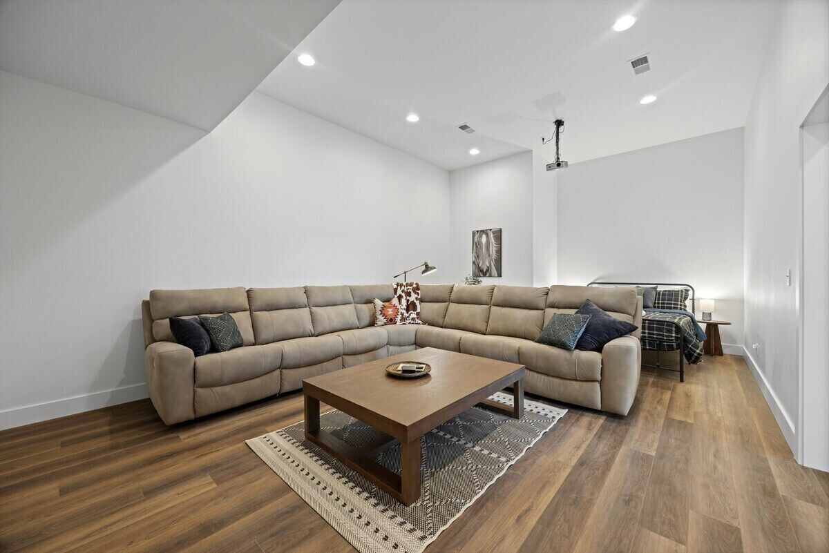 A modern living room with a sectional sofa, a coffee table, and a small side table.