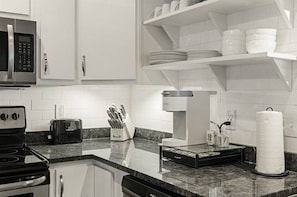 Start your morning at the Keurig coffee station beneath the open shelving.