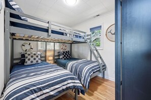 A bunk bed room with two beds, a ladder, and a window with a view of greenery. - Lake front/Hot Tub/Game Room/Dock  Home in Lexington, NC (Lexington)