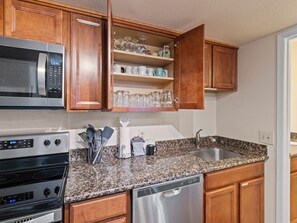 A kitchen with wooden cabinets, a microwave, a stove, and a dishwasher. - Red Pine A8 | Pools | Hot Tubs | Balcony | BBQ | Sleeps 8 (Park City)