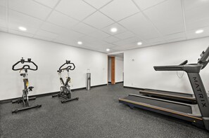 A gym with stationary bikes, a treadmill, and a water dispenser. - Red Pine A8 | Pools | Hot Tubs | Balcony | BBQ | Sleeps 8 (Park City)