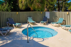 A swimming pool with lounge chairs and a wooden fence. - Egret Point HH-3 Bed/3 bath Condo- FREE golf for foursome daily; Full kitchen (Hilton Head Island)