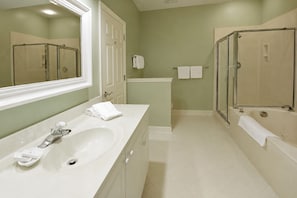 A bathroom with a large mirror, a sink, a bathtub, and a shower area. - Egret Point HH-3 Bed/3 bath Condo- FREE golf for foursome daily; Full kitchen (Hilton Head Island)