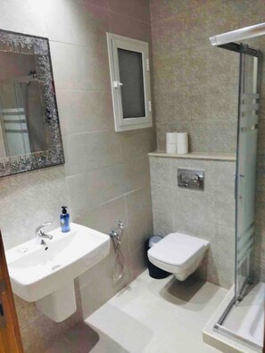 A bathroom with a sink, toilet, and shower. - The Wonderful “Sunset Bay” of Banlieue Nord (Zayatine)
