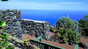 A stone wall with a view of the ocean.
