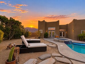 A pool area with lounge chairs, a hot tub, and a view of mountains at sunset. - Mountain View Santa Fe Villa with Private Spa, Heated Pool by Joshua Tree (Desert Hot Springs)