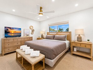 A bedroom with a bed, bedside tables, a bench, a ceiling fan, a TV, and a window with a view. - Old Town 5 Min, Heated Pool & Spa & Putting Green (Scottsdale)