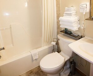 A bathroom with a bathtub, toilet, and a sink. - 1 Bedroom 1 Bath Cabin with hot tub (Beaver, WV) (Beaver)