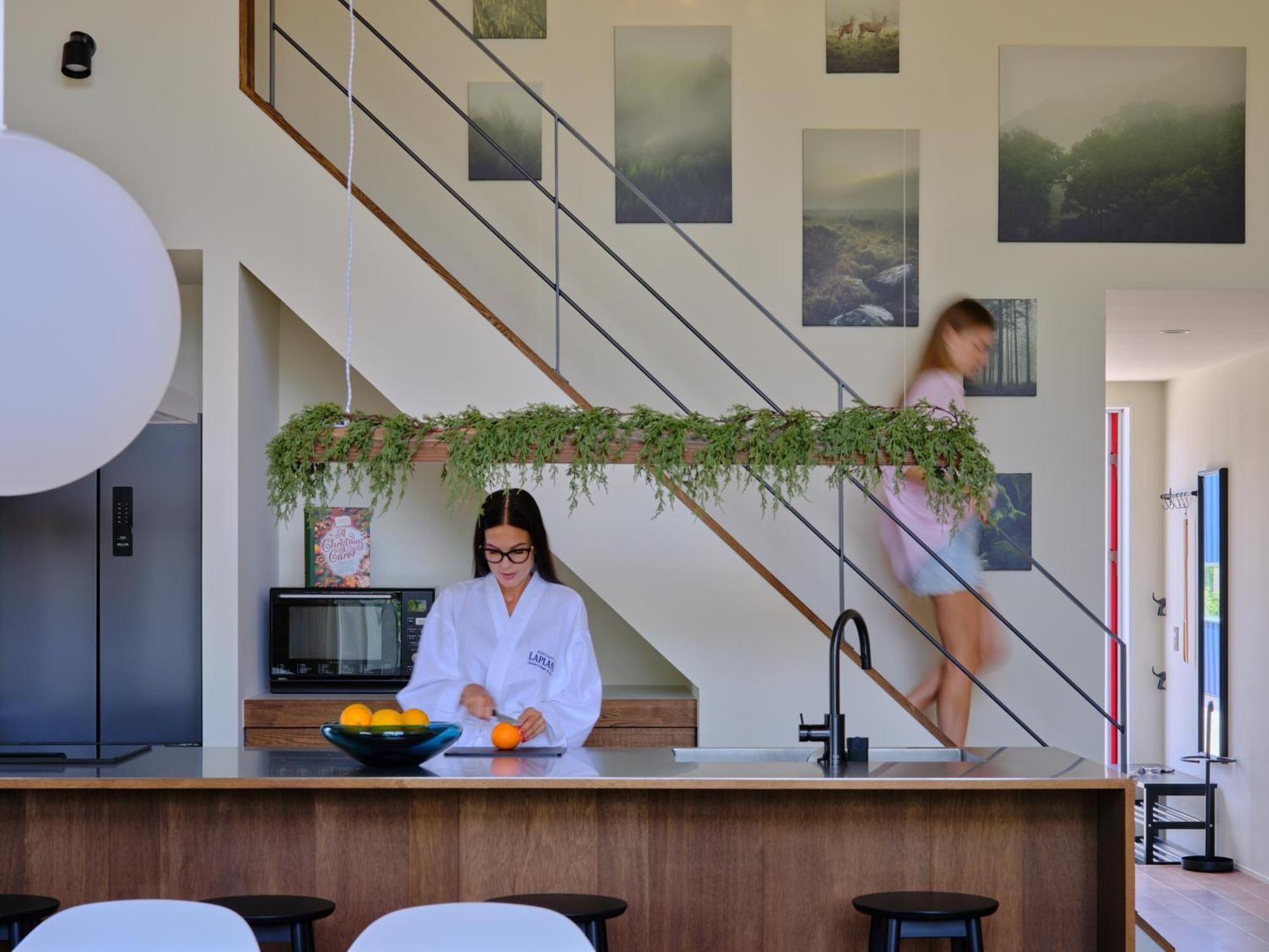 A modern kitchen with a central island, a microwave, and a sink.